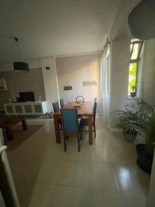 a kitchen and dining room with a table and chairs at Daloba House in Costa da Caparica +10 photos
