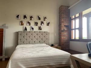 - une chambre avec un lit et des photos sur le mur dans l'établissement Finca con caballos para 10 personas en Envigado, à Envigado