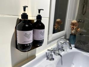 two bottles of wine sitting on a bathroom sink at Seddon Studios in Melbourne +10 photos