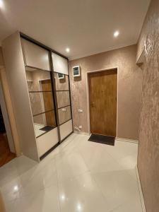 a room with a door and a tiled floor at Apartamenty u Ksyu in Pizunda