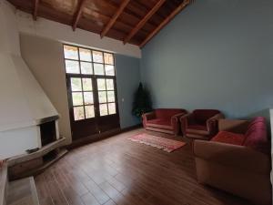 a living room with two couches and a fireplace at casa flores in Ollantaytambo