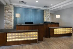 an office lobby with two desks and two lamps at The Scenic Hotel at Biltmore Village in Asheville