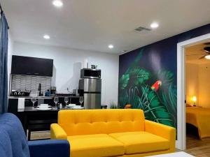 a living room with a yellow couch and a kitchen at Phoenix Retreat - 1 Bedroom King Suite with 2 Smart TVs - 10 min from Airp - Unit B in Phoenix