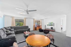 a living room with a couch and a table at Econo Lodge Waterford in Loganlea