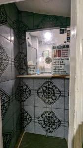 a shelf in a bathroom with a tiled wall at Airport Motel - Inglewood in Inglewood