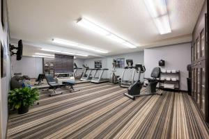 a gym with treadmills and elliptical machines at Sonesta Simply Suites Huntsville Research Park in Huntsville
