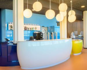 a bar in a restaurant with a counter at prizeotel Dortmund-City in Dortmund