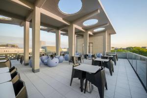 a cafeteria with tables and chairs on a roof at Prize by Radisson, Dortmund City in Dortmund