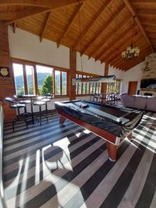 a large room with a pool table in a house at Rancho Ecoturistico Grevillea 