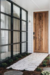 a front door of a house with black windows at Maple Cottages, Berry - by Linnaeus Collection in Berry