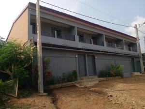 a house with a fence in front of it at Residence Delaure in Bingerville