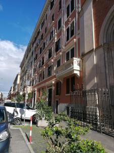 a building on a street with cars parked in front of it at SCIPIO92HOME in Rome