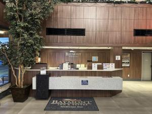 a bar in a building with a reception desk at Baymont by Wyndham Medicine Hat in Medicine Hat