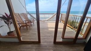 a view of a balcony with a hammock and the beach at Intiquilla Hotel in Manta