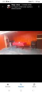 a picture of a red table in a room at Recanto Simões in Itariri