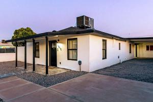 a white house with a window on top of it at Phoenix Retreat - 2 Bedroom Home with King-Size Bed - 3 Smart TVs - 10 min from Airp - Unit A in Phoenix