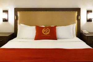 a bed in a hotel room with a red pillow at Super Bowl 2024 Las Vegas Apartment in Las Vegas