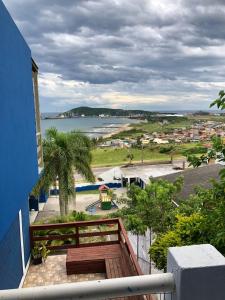 a balcony with a view of a beach and the ocean at Hospedaria Mirante da maré ap2 in Imbituba