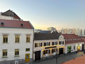 a group of buildings on a city street at Samadhi Aparthotel in Miercurea-Ciuc