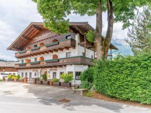 a large white building with trees in front of it at Pension Blaiken L in Scheffau am Wilden Kaiser