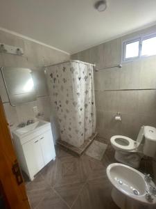 a bathroom with a toilet and a sink at Cabaña Los acantilados in Mar del Plata