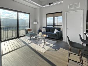 a living room with a couch and a table at 2br Skyline Apt With Panoramic Views Downtown in Des Moines