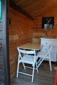 a wooden cabin with a table and two chairs at Kleine Blockhütte im Garten 