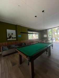 a living room with a pool table in it at Apartamento GolfVille Residence in Aquiraz