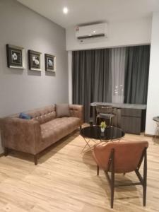 a living room with a couch and a table at Sentral View Hotel Bintulu in Bintulu