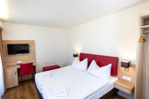 Un pat sau paturi într-o cameră la Hotel Alexander