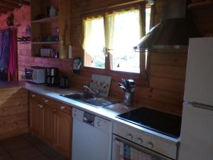 a kitchen with a sink and a stove top oven at Gîte Le Tholy, 4 pièces, 6 personnes - FR-1-589-121 in Le Tholy