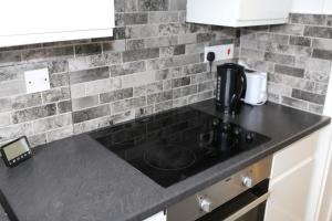 a kitchen counter top with a coffee maker on it at 2 bedroom apartment with balcony near Tottenham Hostpur Stadium in Edmonton