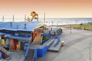 a train station next to the beach with the ocean at Charming Studio by the Beach with Hot Tub in Frankston