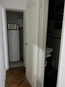 a door to a room with a refrigerator and a microwave at Flat Copacabana Posto 4 in Rio de Janeiro