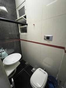 a small bathroom with a toilet and a sink at Flat Copacabana Posto 4 in Rio de Janeiro