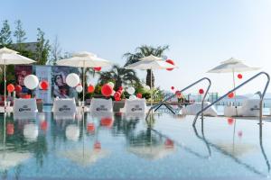 a swimming pool with umbrellas and chairs and a pool at Yeosu Calacatta Hotel & Resort in Yeosu