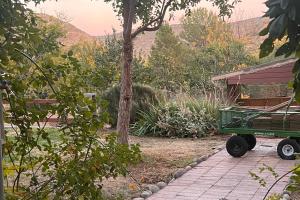 a green wagon parked next to a house at Sunshine House - Stunning Hillside Garden Views in Cottonwood