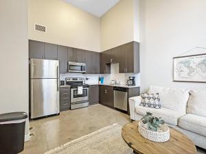 a living room with a couch and a kitchen at Large 1 Bed Apt In The Heart Of Downtown in Des Moines