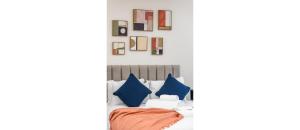 a bedroom with blue and orange pillows on a bed at Tranquil Retreat in Hendon: Comfort & Style Await in The Hyde
