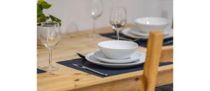 a table with two glasses and a bowl and a plate at Tranquil Retreat in Hendon: Comfort & Style Await in The Hyde