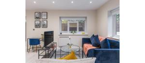 a living room with a blue couch and a table at Tranquil Retreat in Hendon: Comfort & Style Await in The Hyde