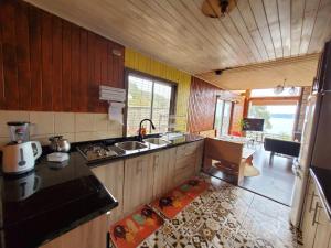 a kitchen with a sink and a counter top at Acogedora Cabaña en la playa in Valdivia