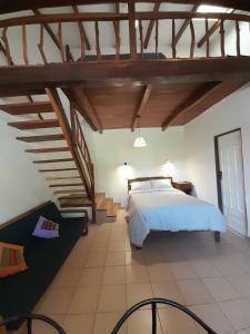 a bedroom with a white bed and a staircase at Fonda Amboró in Samaipata