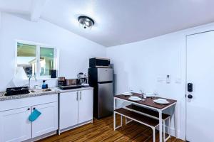 a kitchen with a small table and a refrigerator at Phoenix Retreat - Studio with King Bed - 10 min from Airp - Unit C in Phoenix