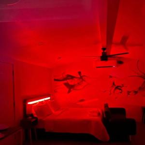 a red room with a bed and a red light at Phoenix Retreat - Studio with King Bed - 10 min from Airp - Unit C in Phoenix