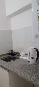 a kitchen counter with a sink and a toaster at La lunita 1 in Córdoba