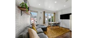 a living room with a couch and a table at Spacious Two Bedroom Apartment in Wood Green in London