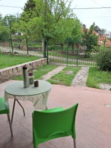 een tafel en twee groene stoelen op een patio bij Paraíso de Mayú in San Antonio de Arredondo