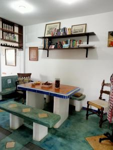 a room with a table and some chairs and books at Los Pinos condominio piso 2 in Zorritos