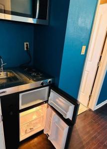 a kitchen with a stove and an open refrigerator at A place like nowhere else in Lawton